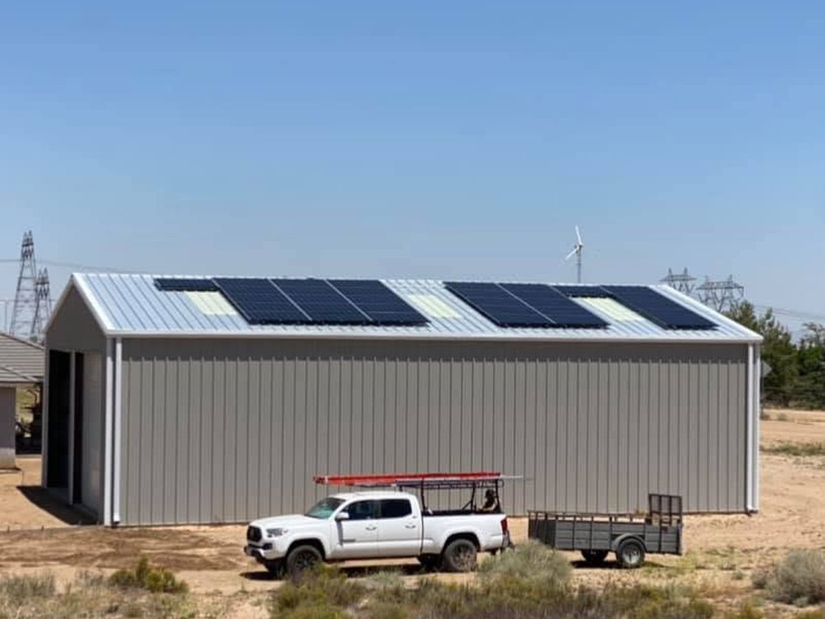 Roof-mounted solar array on a steel shop building in the California High Desert, installed by Van Mierlo Builders and Solar